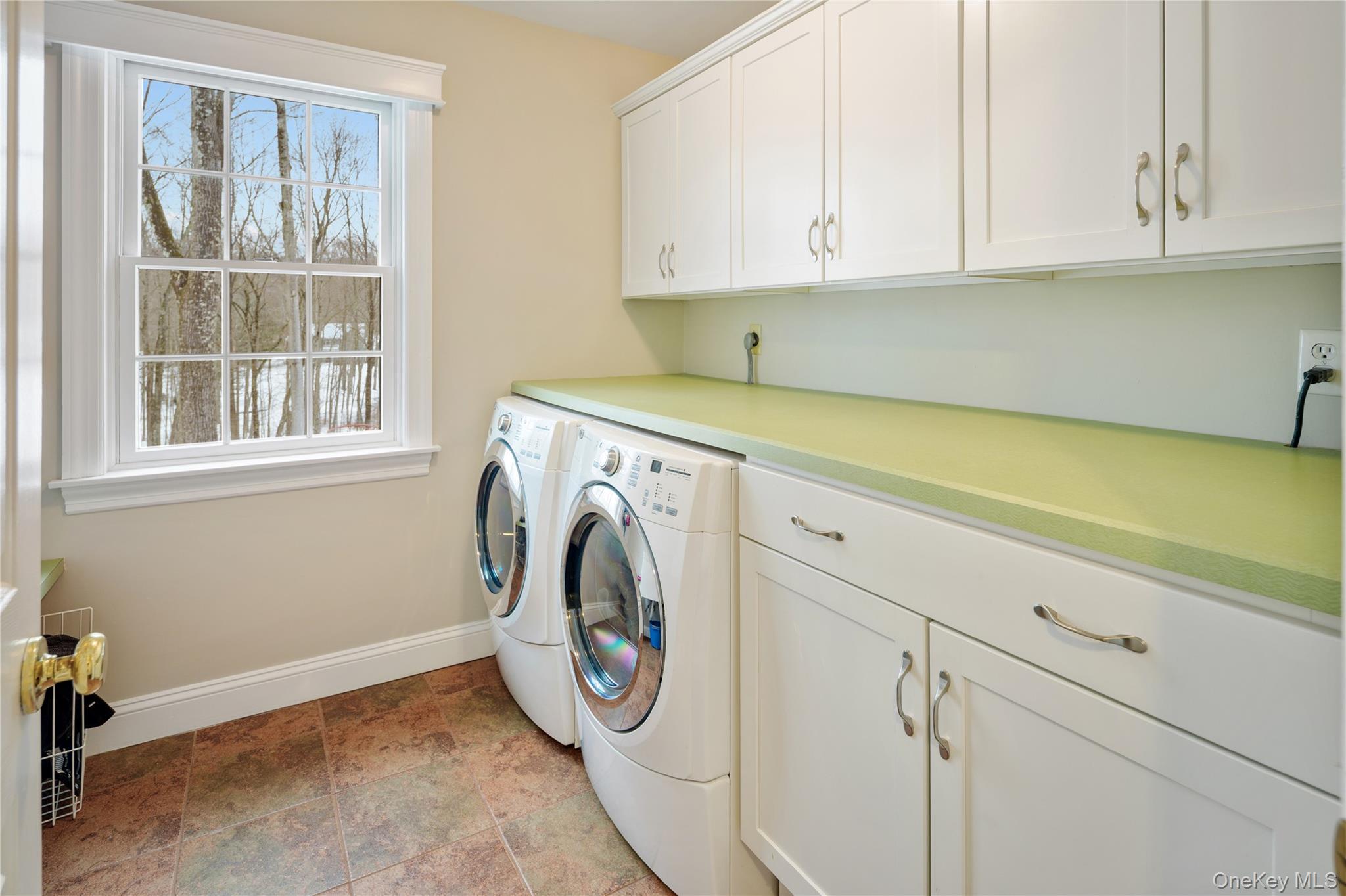 14 Adams Farm Road Katonah, NY 10536 - Photo 27 of 47 Main floor laundry room with utility sink, storage cabinetry, folding counter, hanging rod