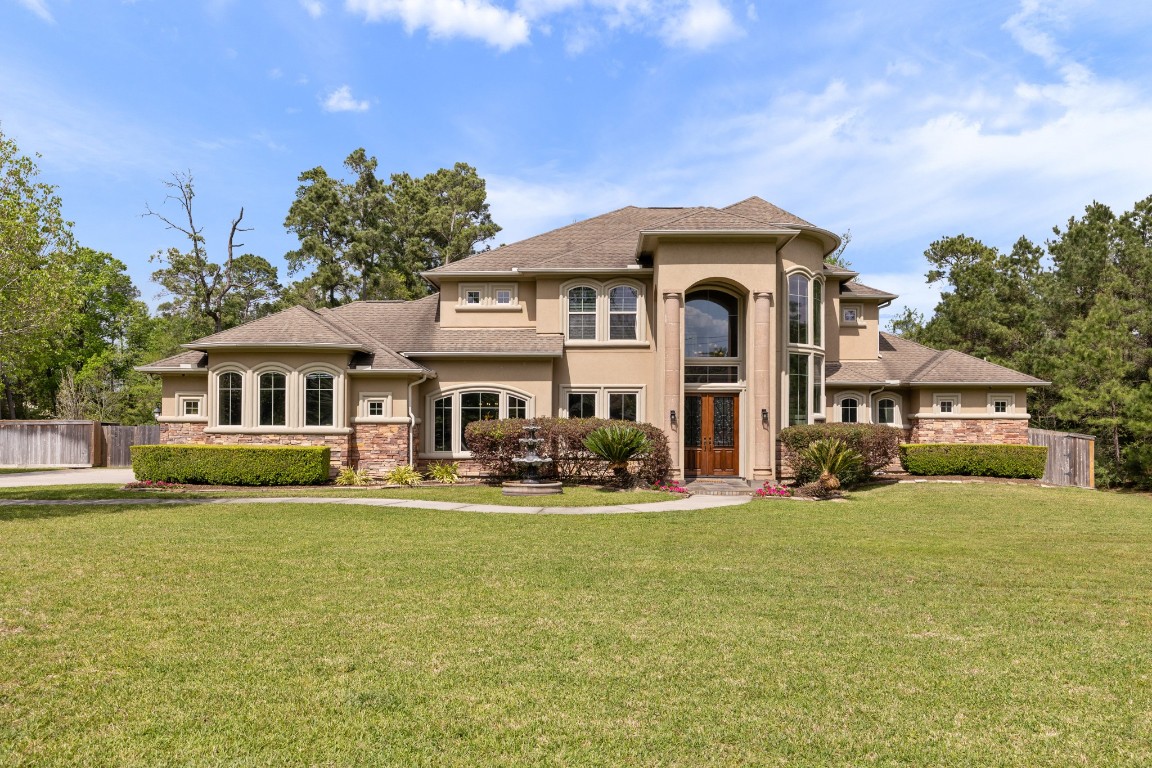 4447 Chateau Creek Way Spring, TX 77386 - Photo 2 of 50 a front view of a house with a garden and yard