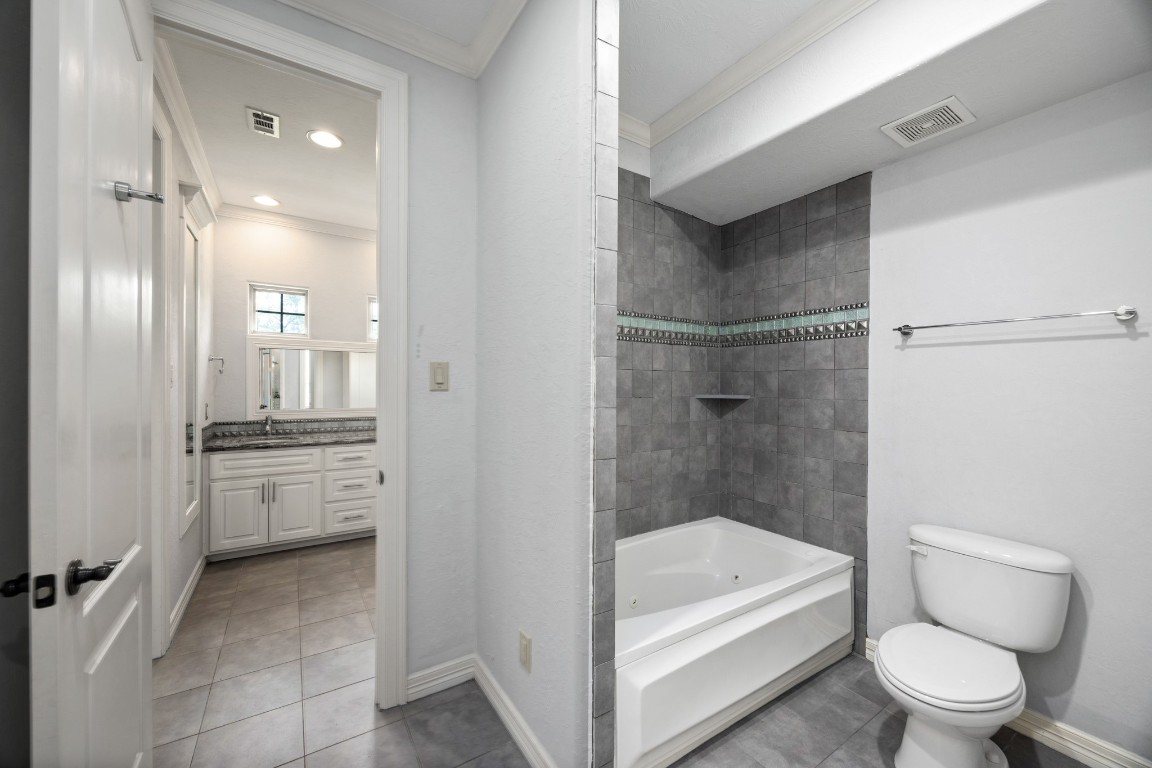 4447 Chateau Creek Way Spring, TX 77386 - Photo 31 of 50 a bathroom with a tub shower sink vanity and toilet