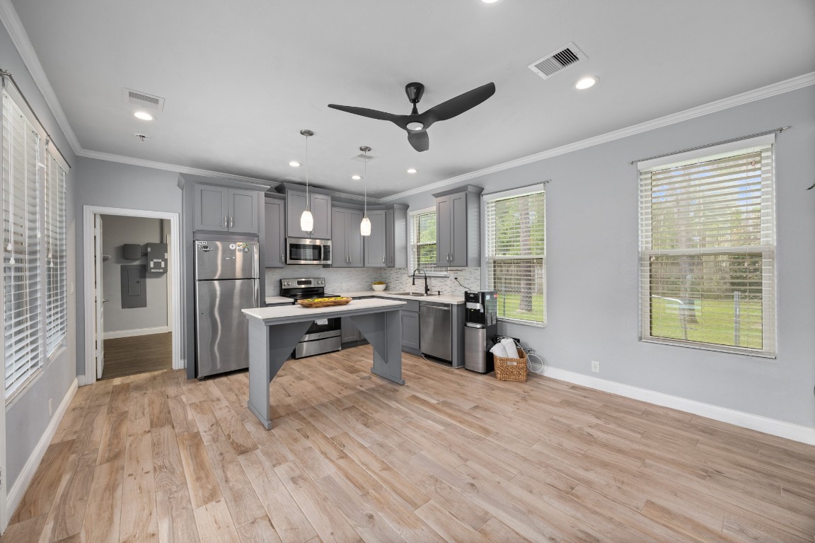4447 Chateau Creek Way Spring, TX 77386 - Photo 42 of 50 a kitchen with stainless steel appliances granite countertop a refrigerator oven a sink dishwasher and white cabinets with wooden floor