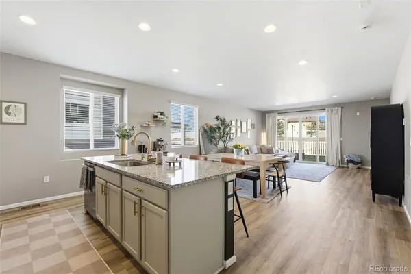 a kitchen with counter top space a sink appliances and cabinets
