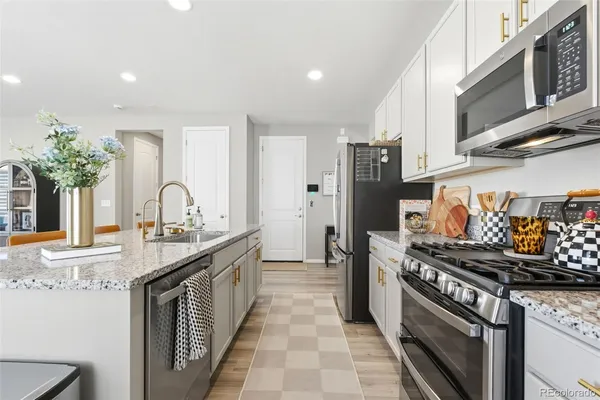 a kitchen with stainless steel appliances granite countertop a stove and a sink