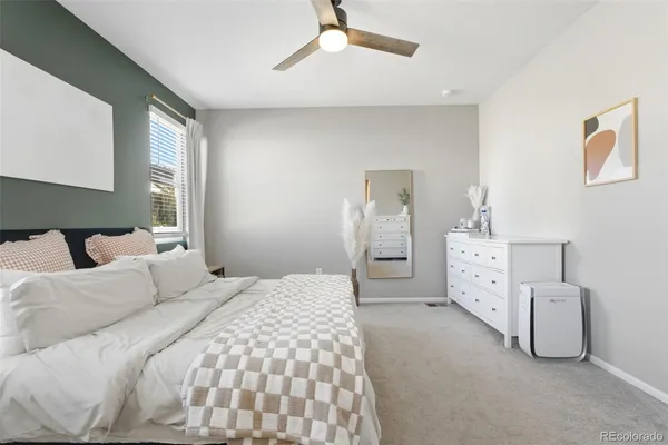 a bedroom with a bed and dresser
