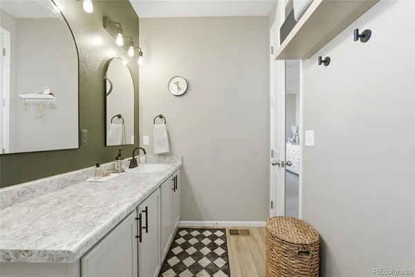 a bathroom with a granite countertop sink and a mirror