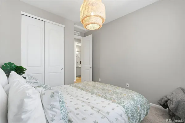 a bedroom with a bed and a chandelier