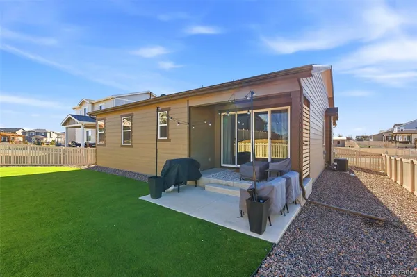 a view of a house with backyard porch and sitting area