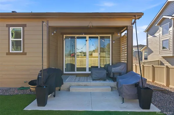 a view of two chairs in the patio