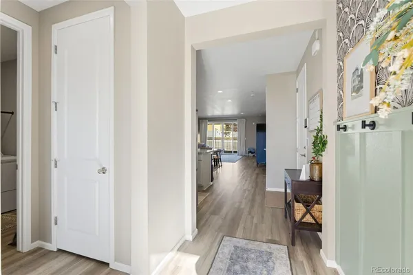 a view of a hallway with wooden floor windows and livingroom