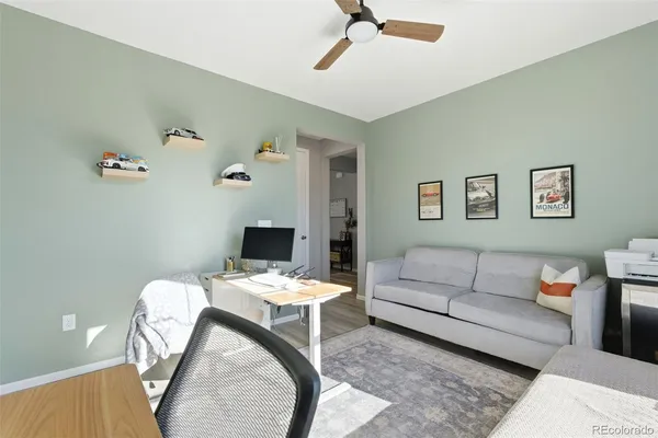 a living room with furniture and a wooden floor