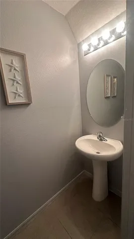 a bathroom with a sink mirror and toilet