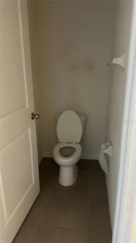 a white toilet sitting in a bathroom next to a sink