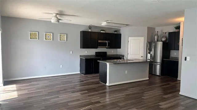 a kitchen with a refrigerator and a stove top oven