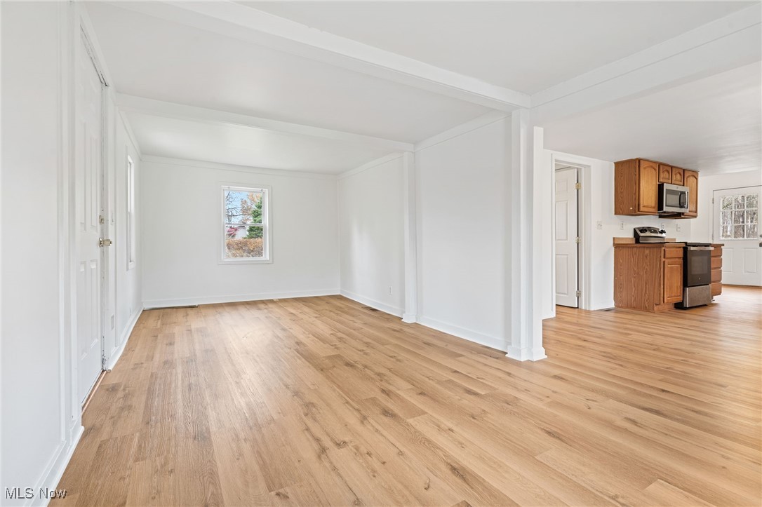 3426 Marsh Road Stow, OH 44224 - Photo 6 of 37 Unfurnished living room featuring light wood finished floors and beam ceiling