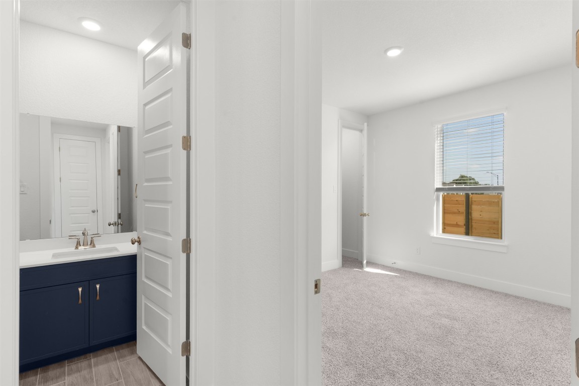 333 Ridgewell Loop Georgetown, TX 78633 - Photo 15 of 29 Bathroom featuring vanity, light colored carpet, and recessed lighting