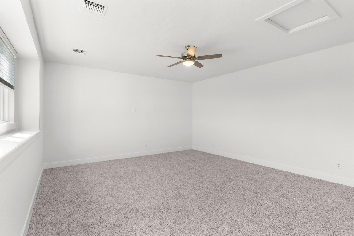 333 Ridgewell Loop Georgetown, TX 78633 - Photo 18 of 29 Spare room featuring light carpet and attic access