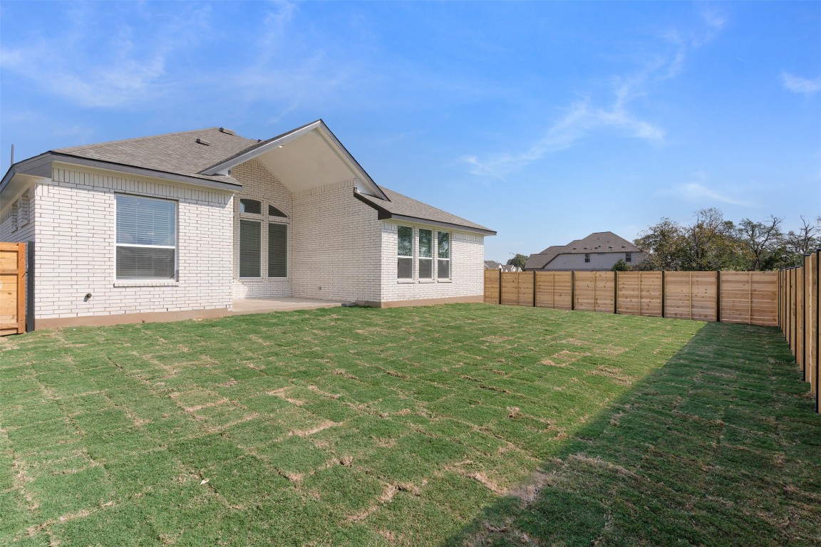 333 Ridgewell Loop Georgetown, TX 78633 - Photo 21 of 29 Rear view of house with a fenced backyard, a patio, and brick siding