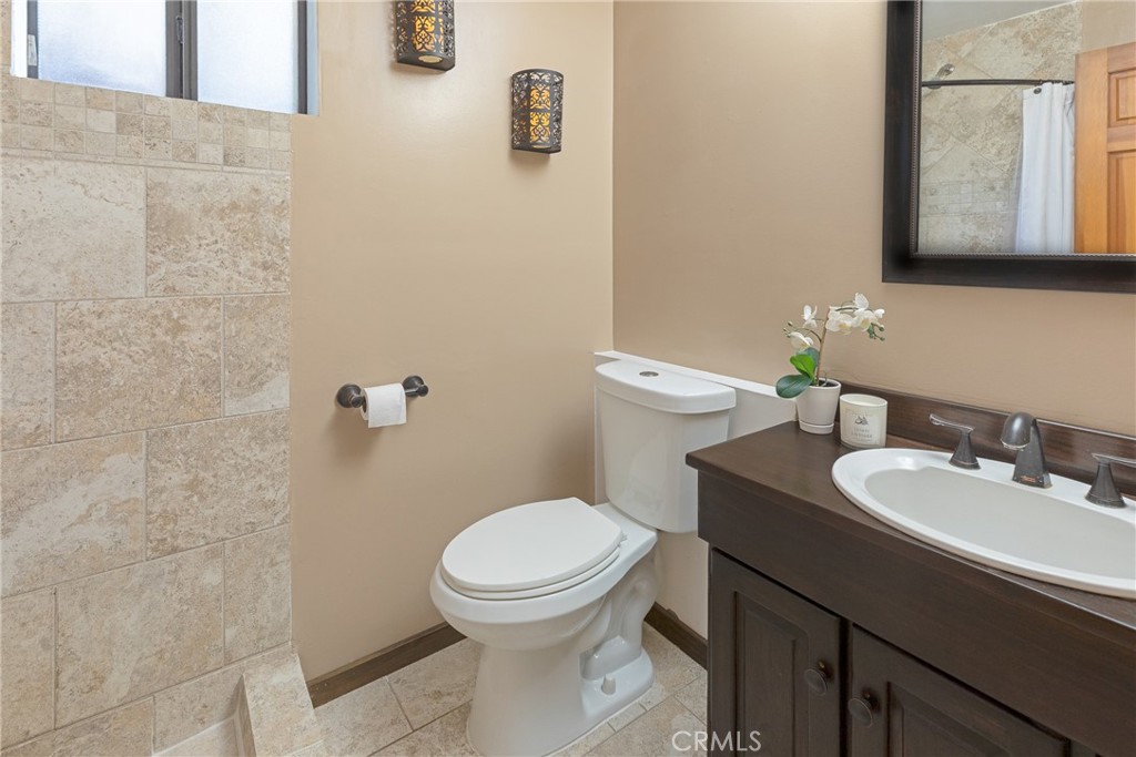 31311 Silverado Canyon Road Silverado, CA 92676 - Photo 11 of 37 a bathroom with a toilet a sink and mirror