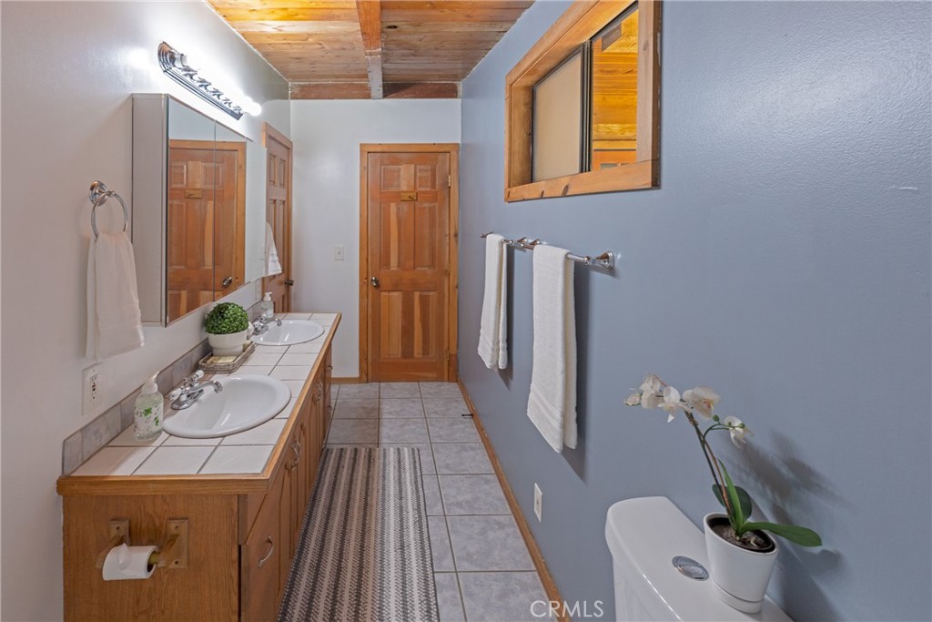 31311 Silverado Canyon Road Silverado, CA 92676 - Photo 30 of 37 a bathroom with a sink mirror and toilet
