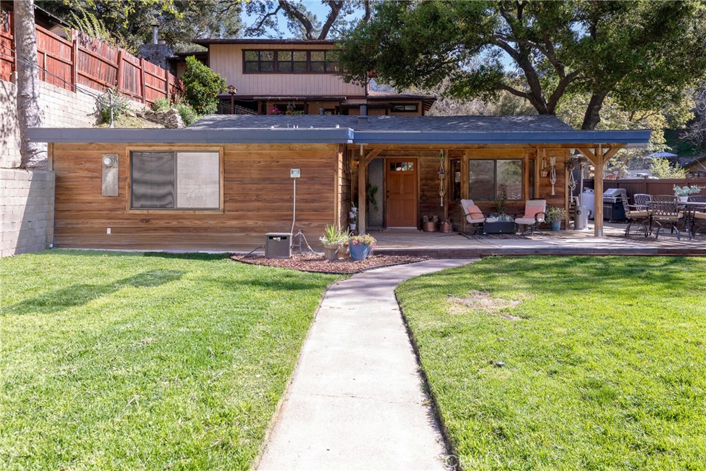31311 Silverado Canyon Road Silverado, CA 92676 - Photo 37 of 37 a view of a patio with a table and chairs under an umbrella