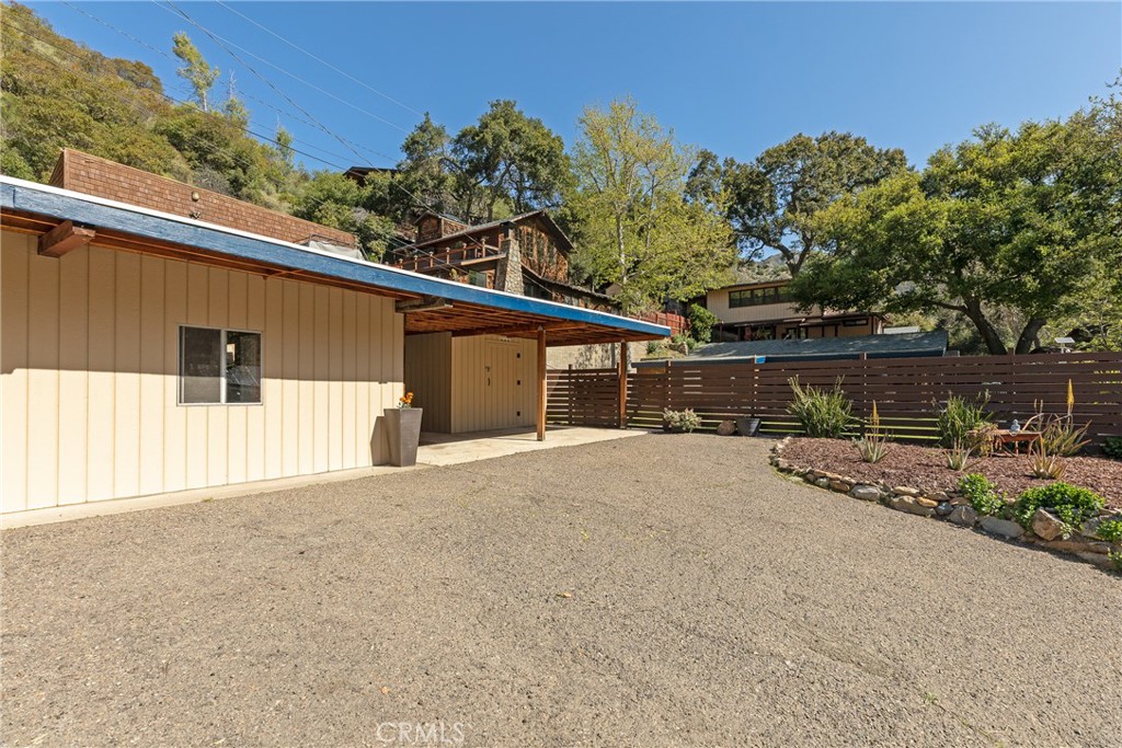 31311 Silverado Canyon Road Silverado, CA 92676 - Photo 4 of 37 a front view of a house with a yard and a garage