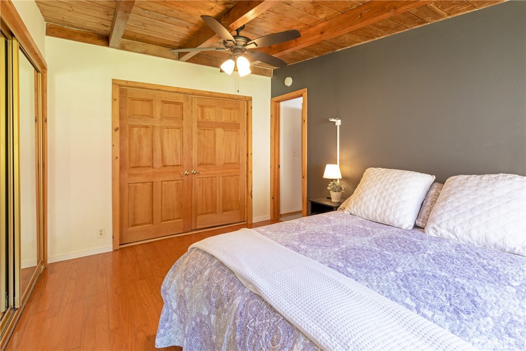 31311 Silverado Canyon Road Silverado, CA 92676 - Photo 8 of 37 a bedroom with a large bed a chandelier and closet