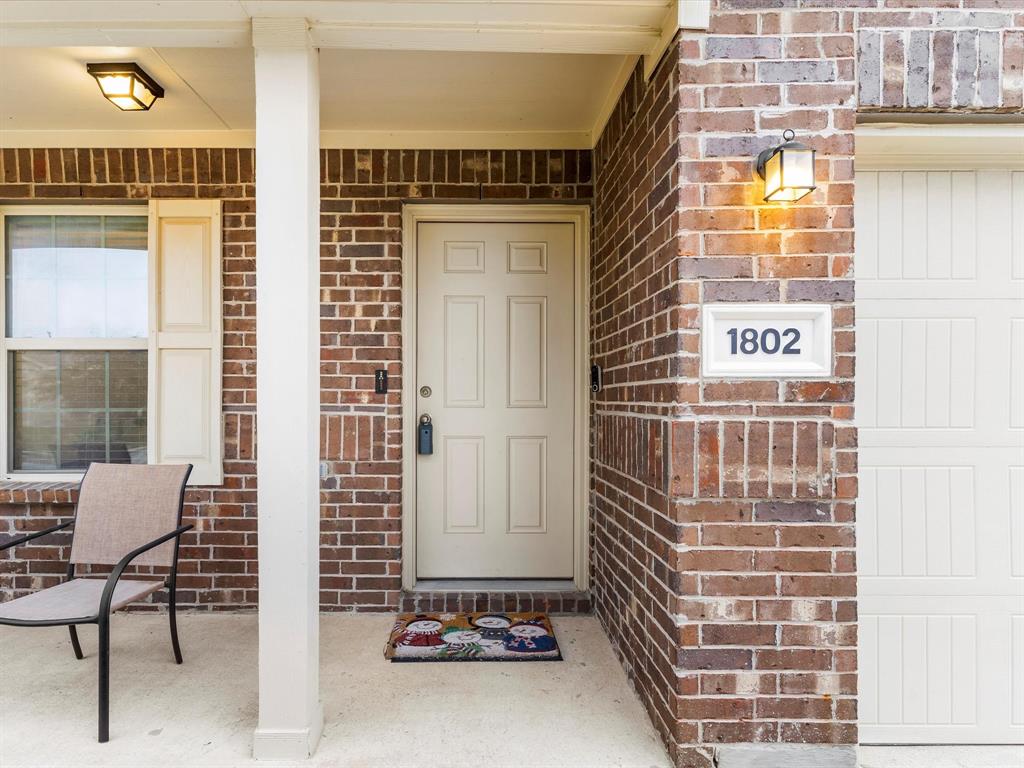 a view of front door of house and a window