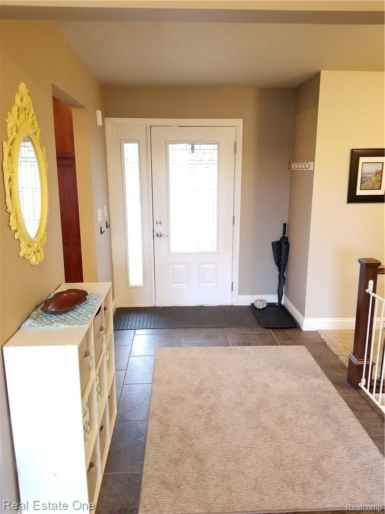 2822 Lone Tree Road Highland, MI 48357 - Photo 6 of 33 Enter the home in a large foyer overlooking both kitchen and Living room.