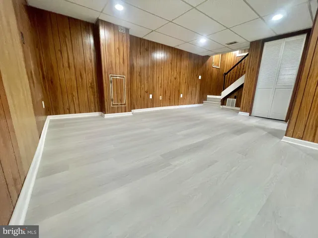 a view of an empty room with wooden walls