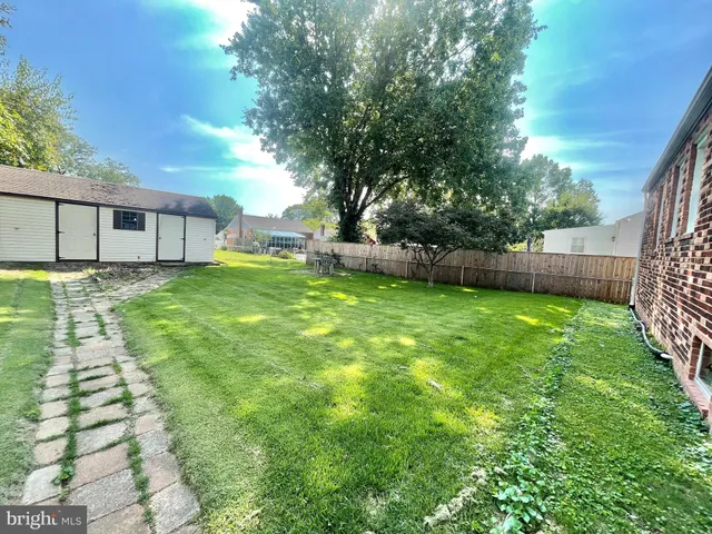 a view of a house with a yard and deck
