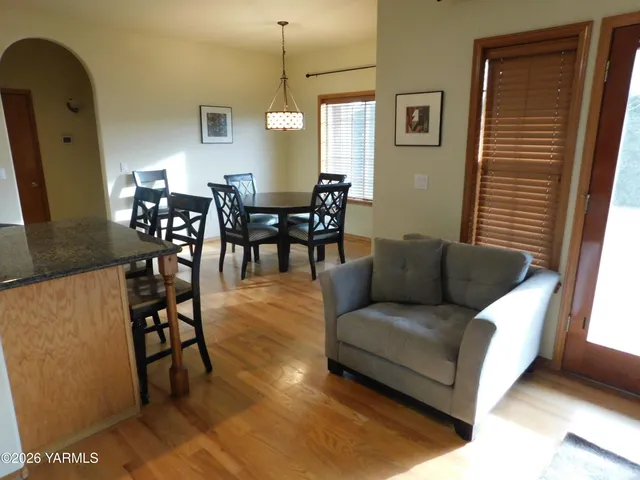 a living room with furniture dining table and a window