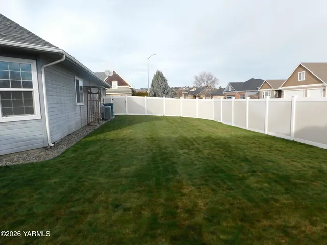 a view of a house with a yard and a fountain