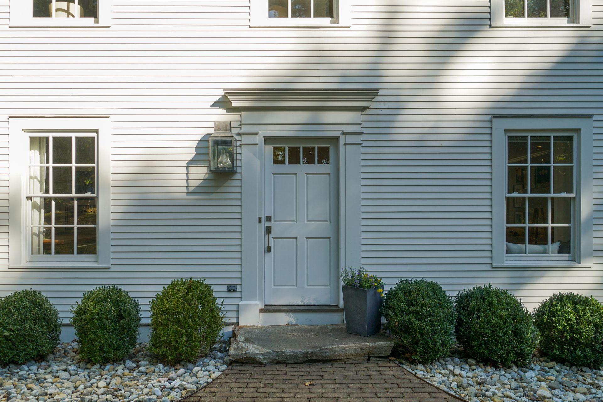 33 Tory Hole Road Darien, CT 06820 - Photo 2 of 51 a view of a house with a window and potted plants