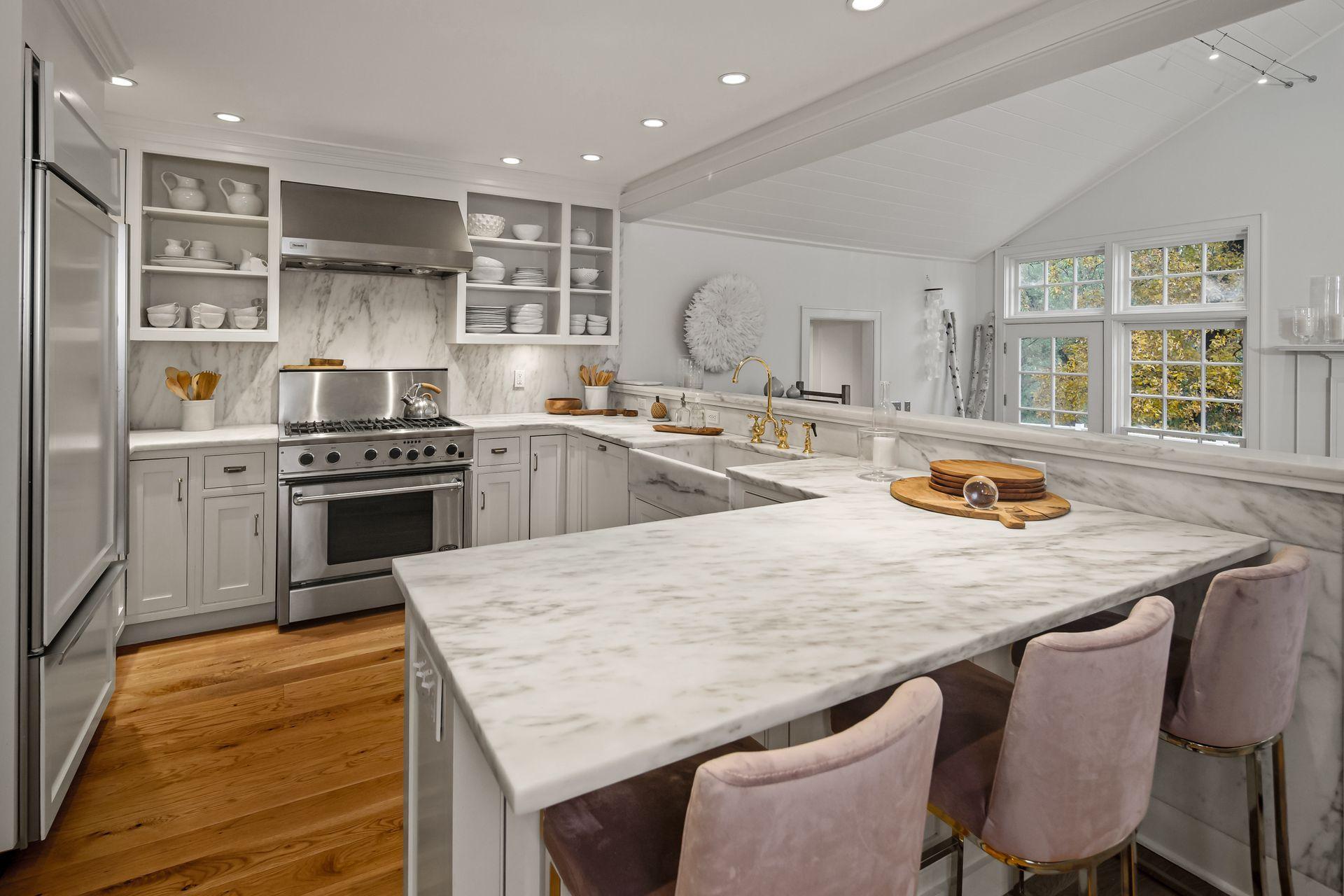 33 Tory Hole Road Darien, CT 06820 - Photo 11 of 51 a kitchen with stainless steel appliances granite countertop a stove a sink a oven a dining table and chairs