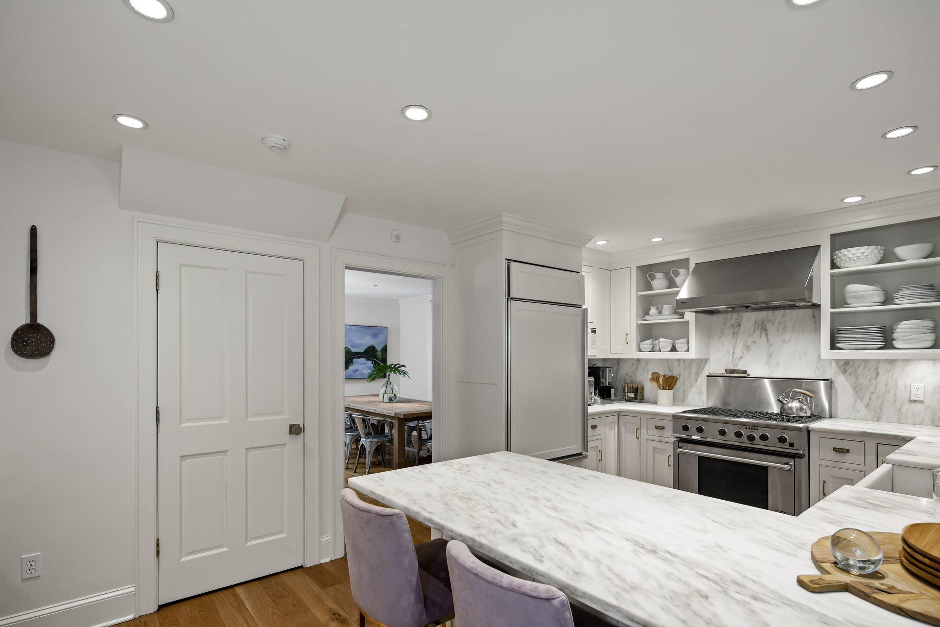 33 Tory Hole Road Darien, CT 06820 - Photo 13 of 51 a kitchen with stainless steel appliances kitchen island granite countertop a sink cabinets and wooden floor