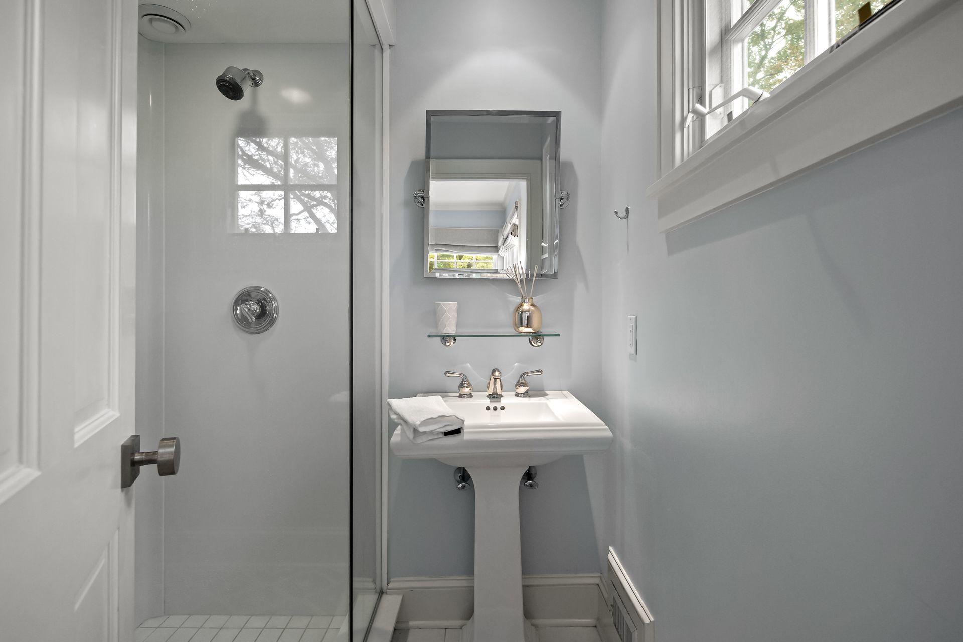 33 Tory Hole Road Darien, CT 06820 - Photo 30 of 51 a bathroom with a sink a mirror and a window