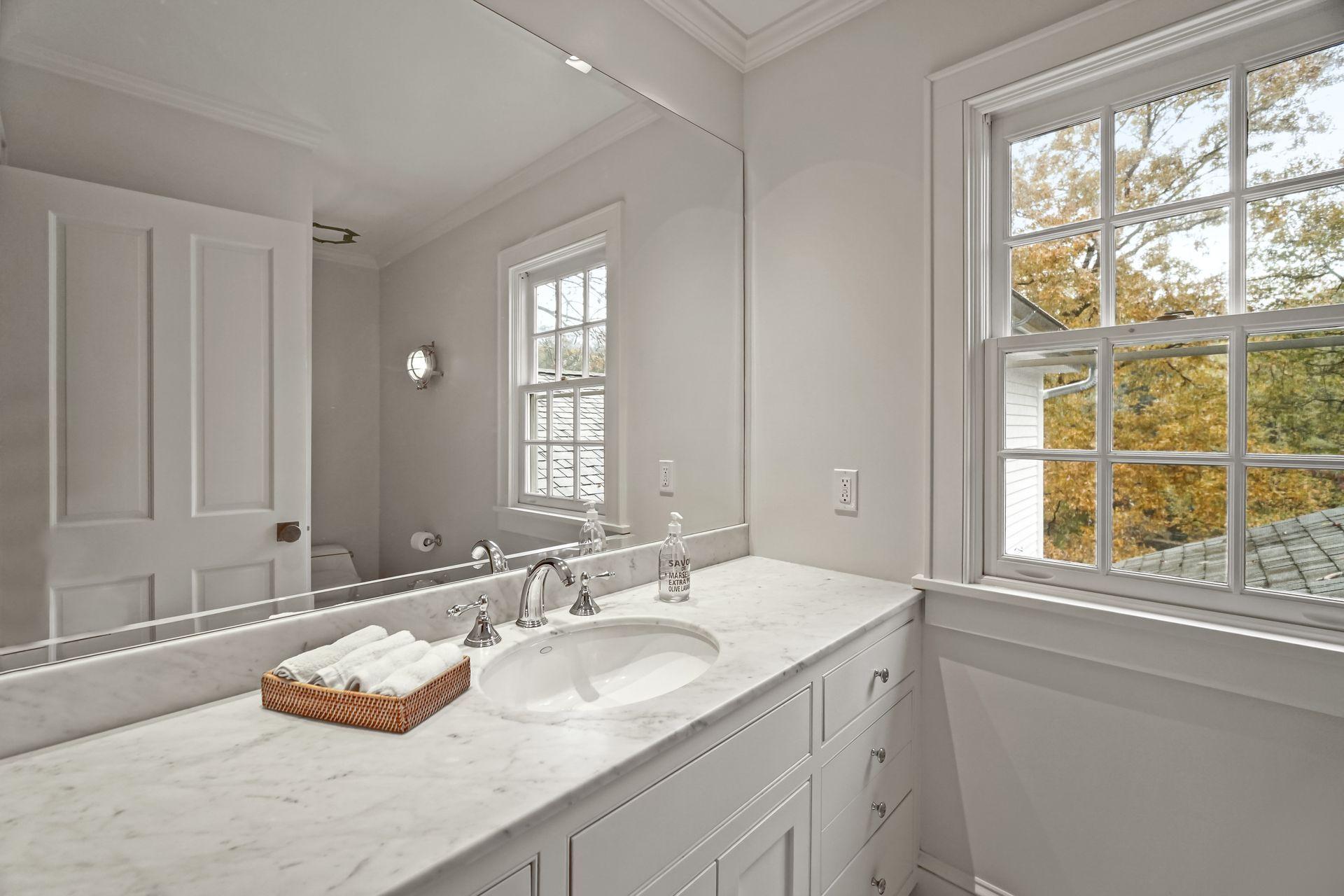 33 Tory Hole Road Darien, CT 06820 - Photo 32 of 51 a bathroom with a granite countertop sink and a window