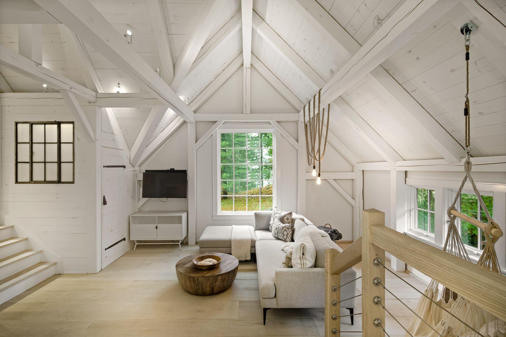 33 Tory Hole Road Darien, CT 06820 - Photo 35 of 51 a living room with furniture a flat screen tv and a large window