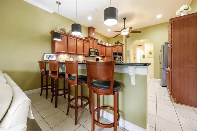 a kitchen with a dining table chairs sink and cabinets
