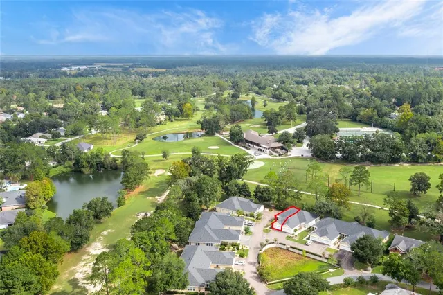 an aerial view of residential houses with outdoor space and lake view