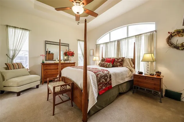 a bedroom with a bed and a chandelier