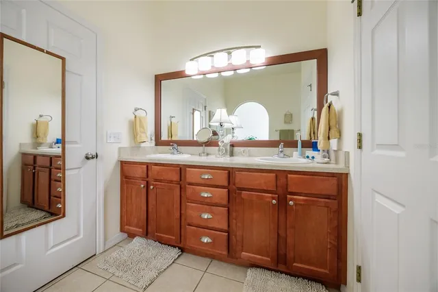 a bathroom with a double vanity sink and a mirror