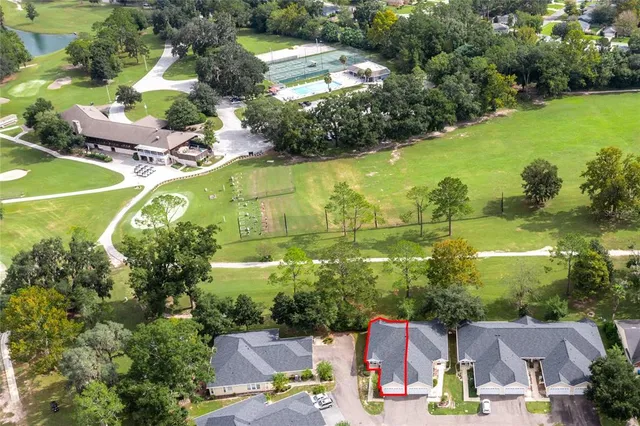 an aerial view of residential houses with outdoor space and swimming pool