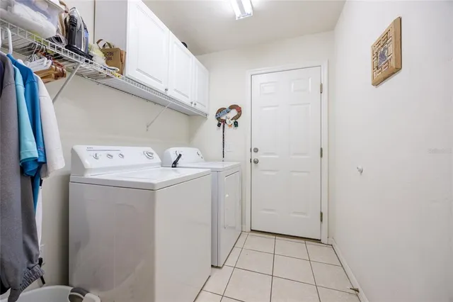 a utility room with a sink washer and dryer