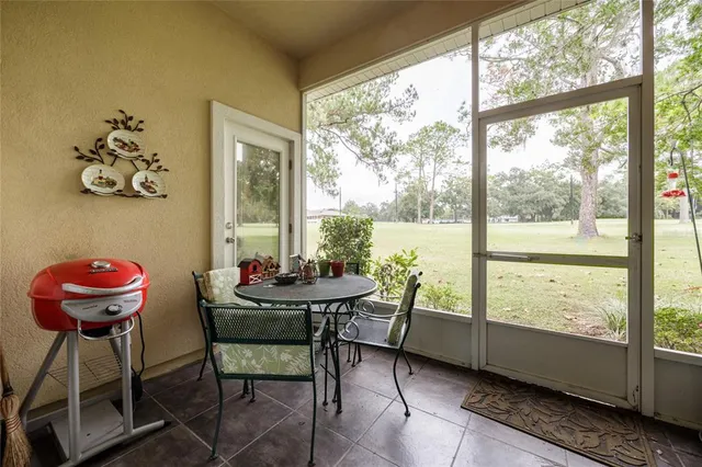 a view of a room with furniture and large windows