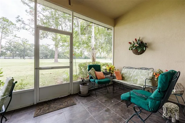 a living room with furniture and floor to ceiling windows
