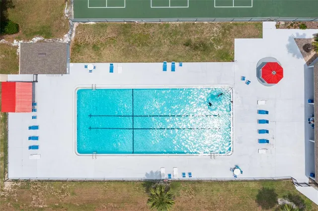 an aerial view of a house with a swimming pool