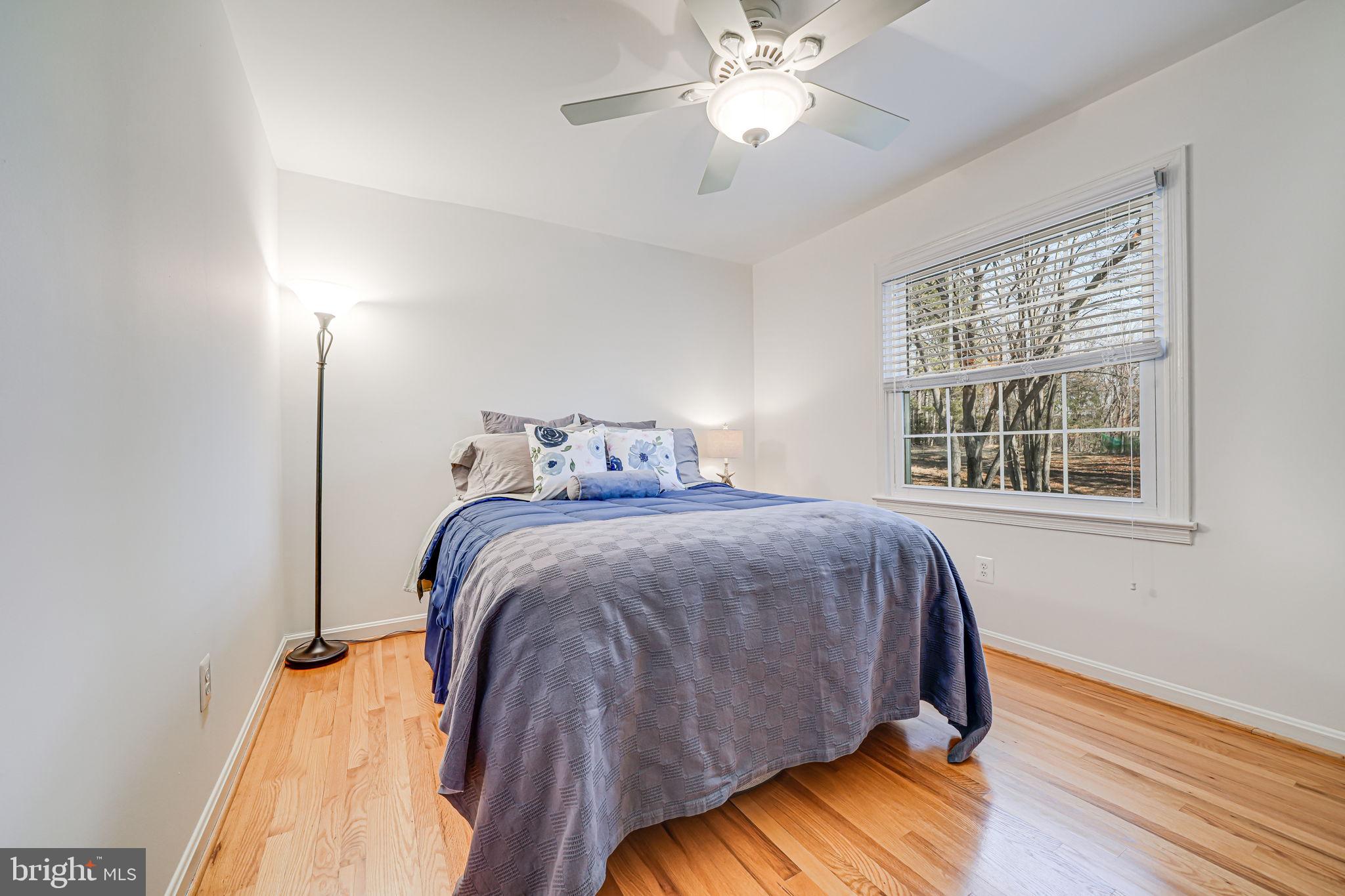 11000 Ring Road Reston, VA 20190 - Photo 21 of 53 a bedroom with a bed and wooden floor
