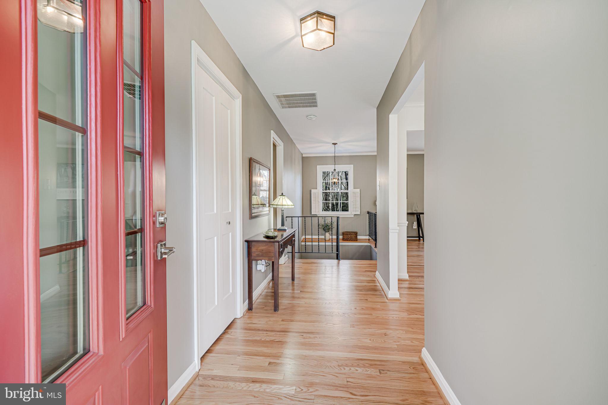 11000 Ring Road Reston, VA 20190 - Photo 4 of 53 a view of a hallway with wooden floor and staircase