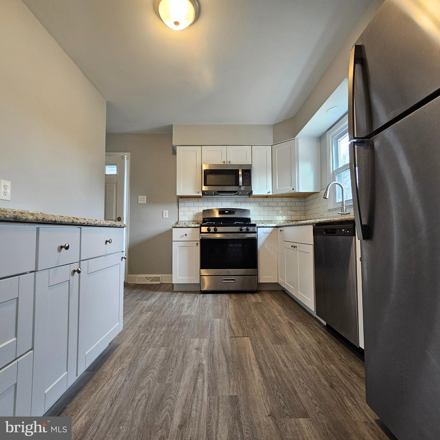 1565 South Main Road Vineland, NJ 08360 - Photo 5 of 15 a kitchen with granite countertop a refrigerator and a stove top oven