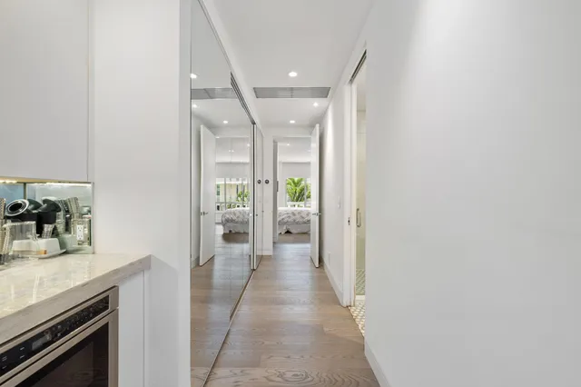 a view of a hallway with wooden floor and a fireplace
